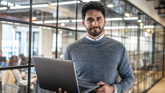 businessman holding laptop