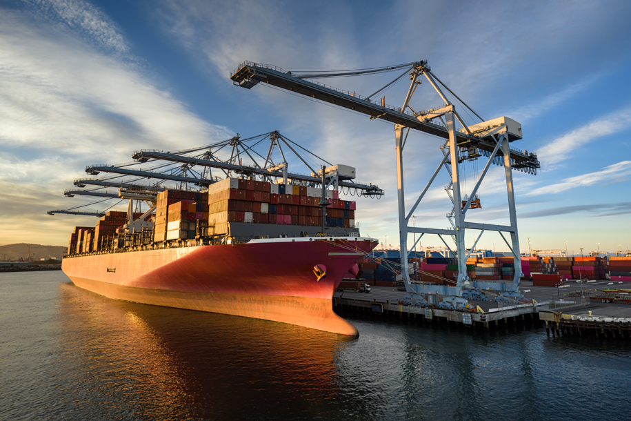 Commercial port crane loading cargo on a ship