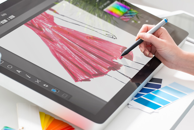 Fashion designer making a digital draw on a screen