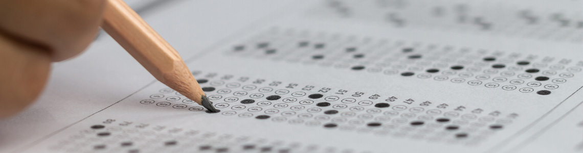 Close up of a pencil completing a standardized test
