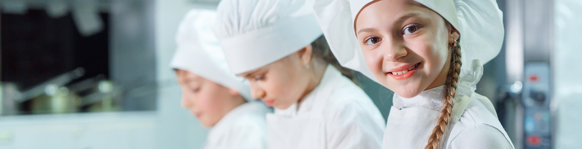 Group of young ladies cooking in a chef outfit