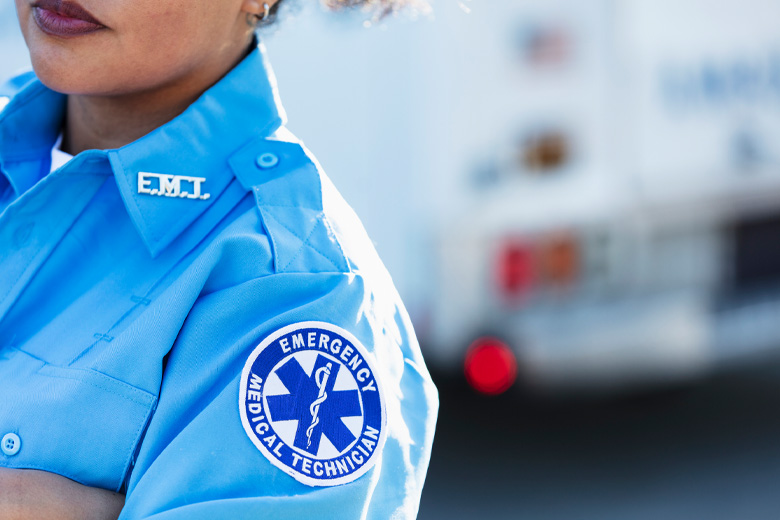Paramedic in a EMT uniform near an ambulance