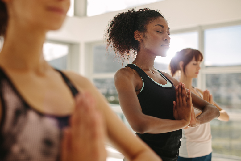 Diverse group of women practicing yoga in a studio