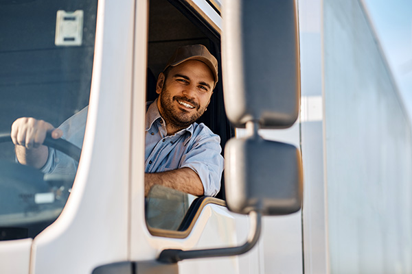 Professional truck driver looking through side windows