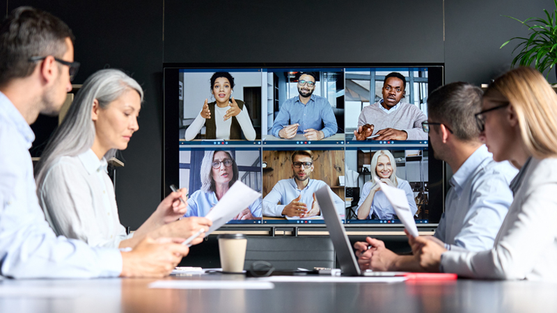 A group of company employees having a virtual meeting with other co-workers
