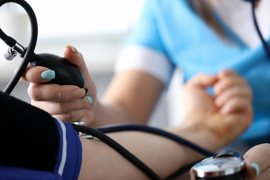 Healthcare nurse measuring blood pressure on a patient